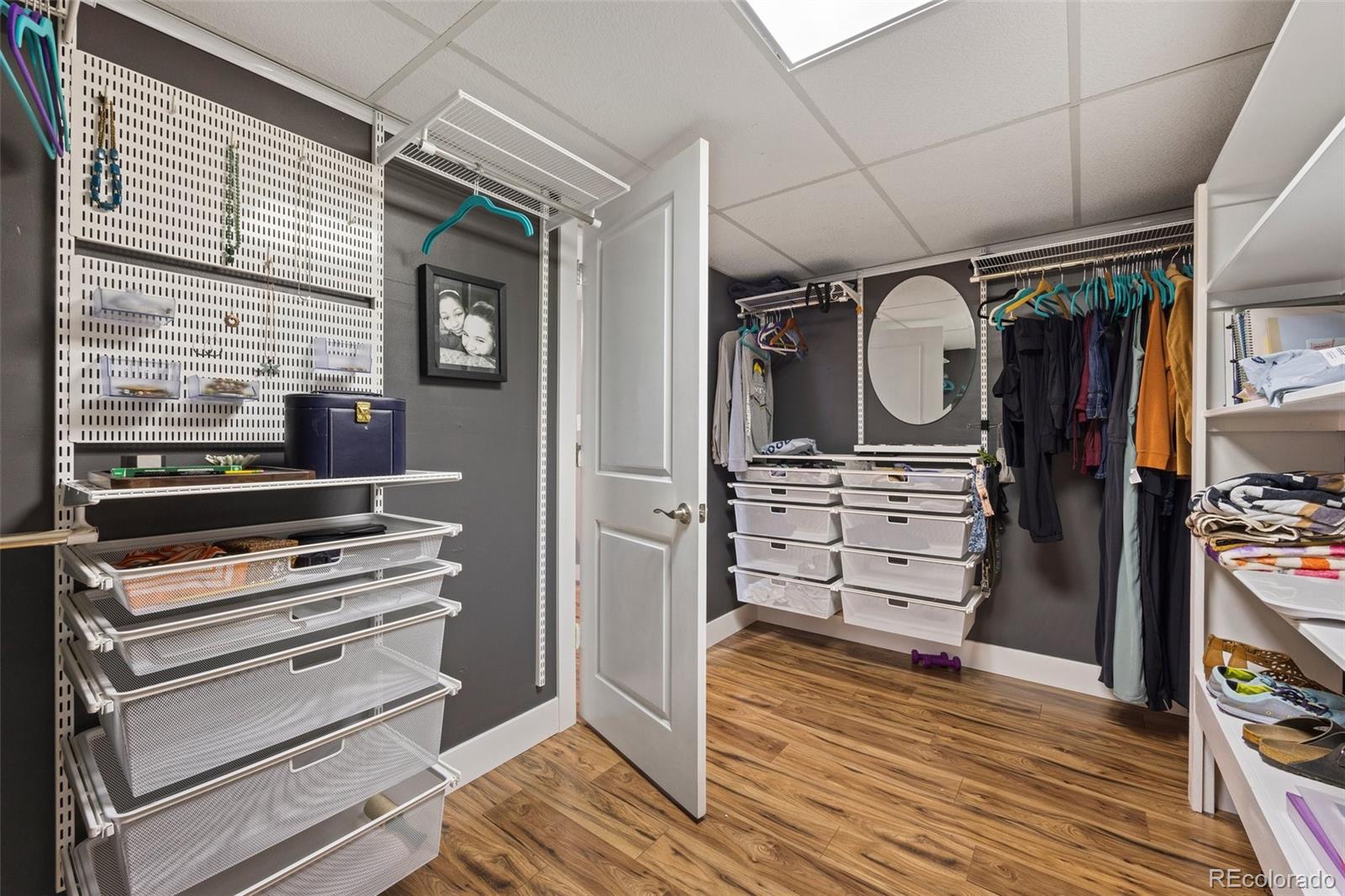 703 South Oneida Way Denver, CO 80224 - Photo 20 of 24 a view of walk in closet with clothes and shoes