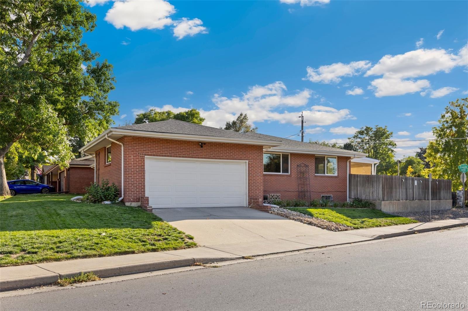 703 South Oneida Way Denver, CO 80224 - Photo 22 of 24 a front view of a house with a yard and garage