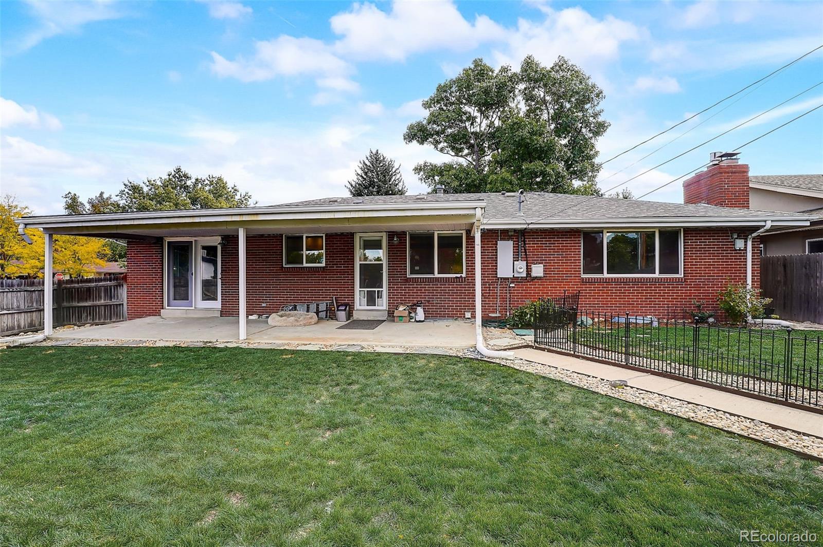 703 South Oneida Way Denver, CO 80224 - Photo 23 of 24 front view of a house with a yard