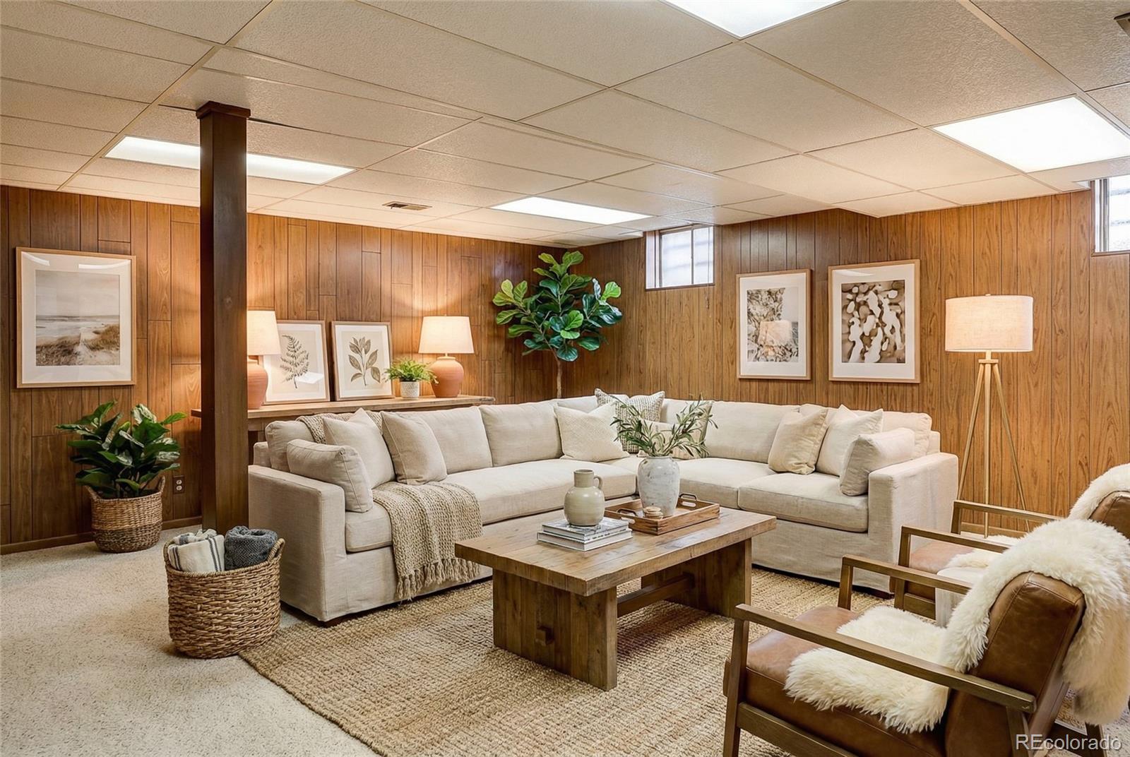 703 South Oneida Way Denver, CO 80224 - Photo 24 of 24 a living room with furniture potted plant and a large window