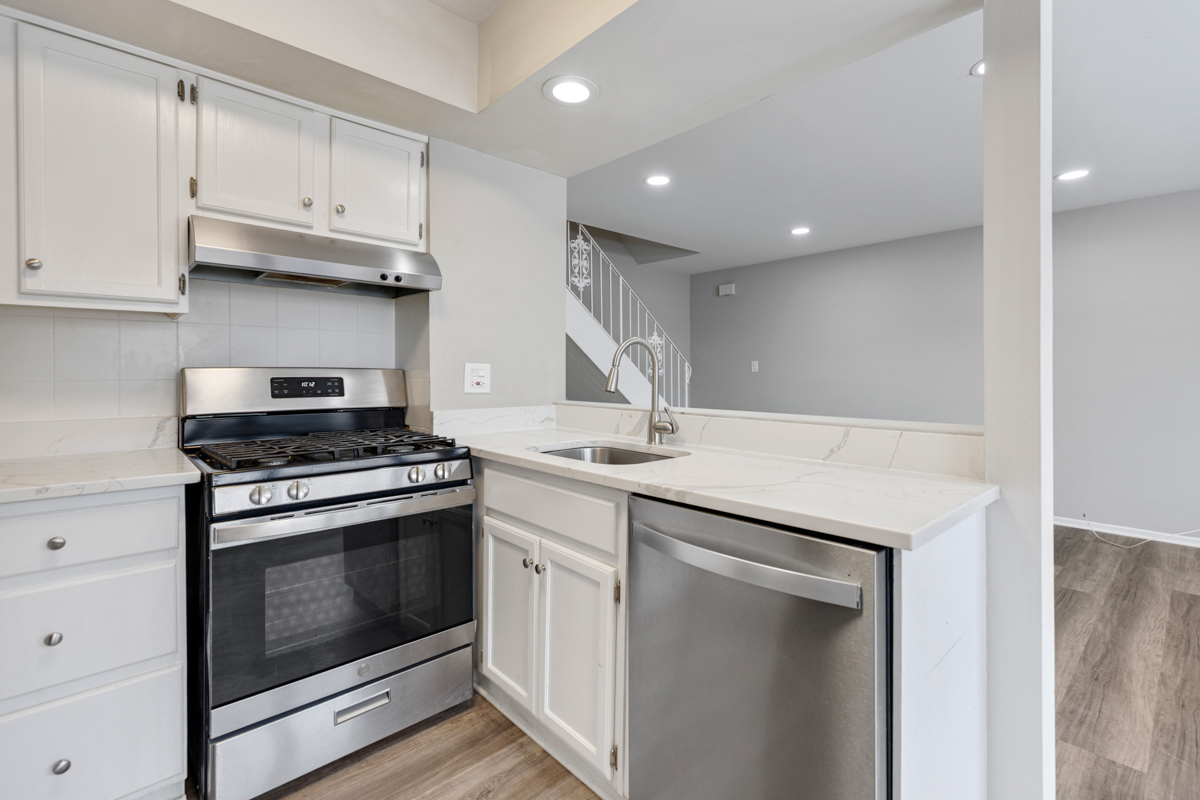 262 Inverrary Lane Deerfield, IL 60015 - Photo 11 of 26 a kitchen with granite countertop a stove sink and cabinets