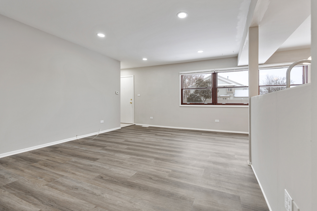 262 Inverrary Lane Deerfield, IL 60015 - Photo 4 of 26 an empty room with wooden floor and windows