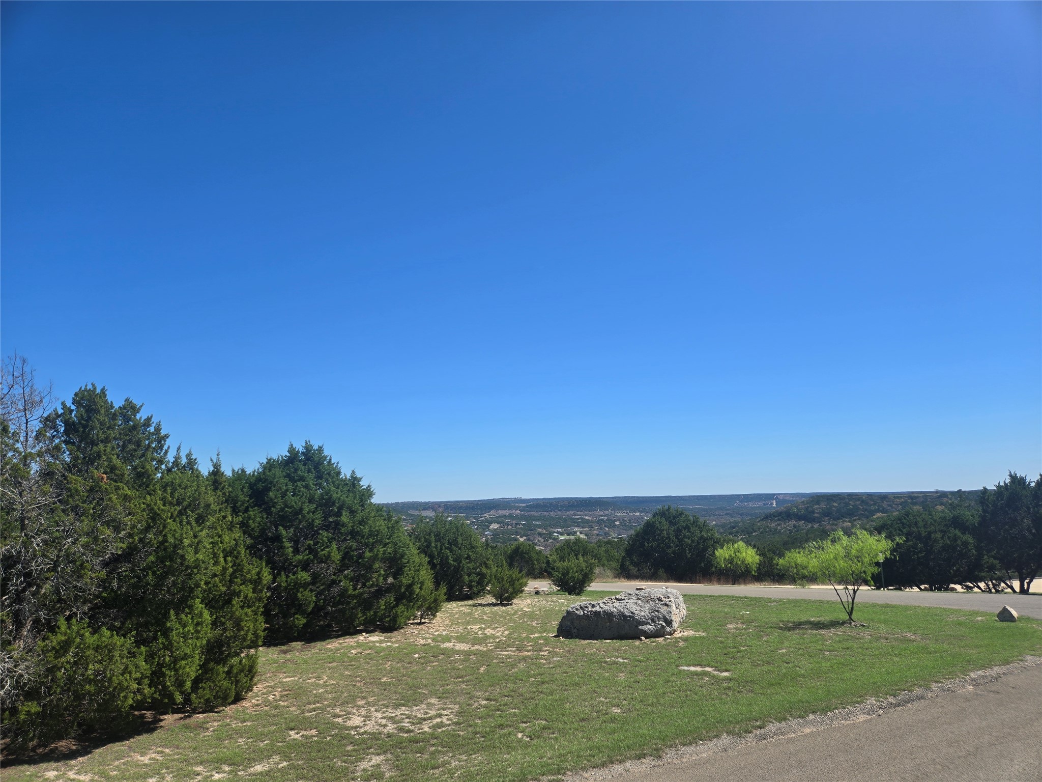 358 Balcones Ridgeway Way Bertram, TX 78605 - Photo 14 of 24 a view of a big yard with a large tree