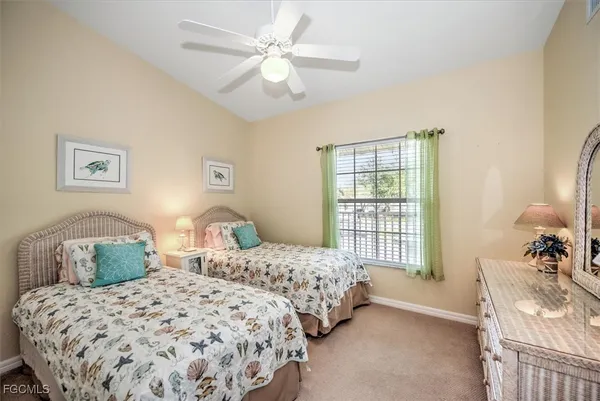 a bedroom with two beds and a window