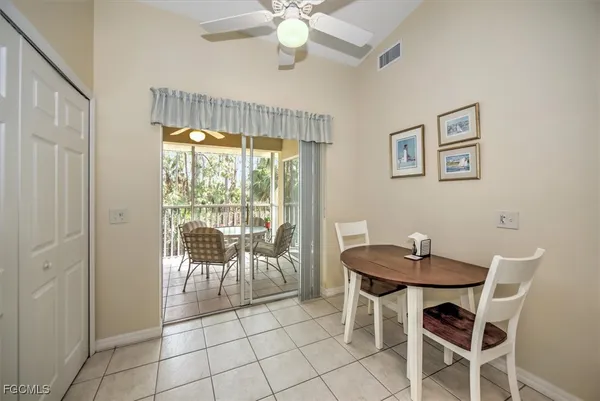 a dining room with furniture and large window