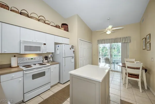 a kitchen with a stove a table and chairs