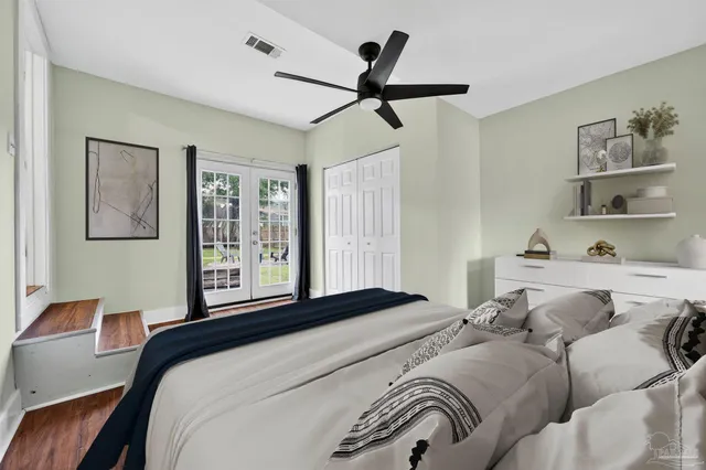 a bedroom with a large bed and a chandelier