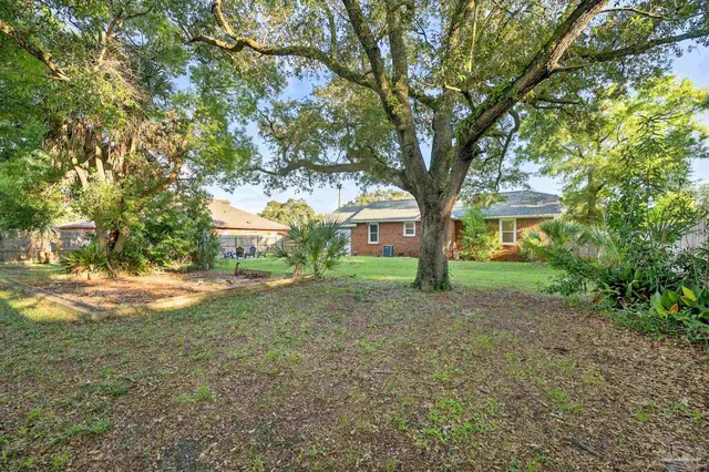 a view of a house with large trees