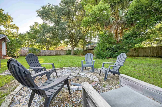 a view of a chairs and table in backyard of the house