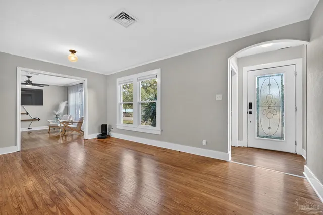 an empty room with piano and wooden floor