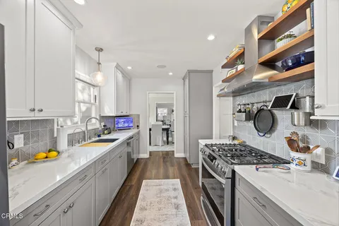 a view of walk in closet with clothes washer and dryer