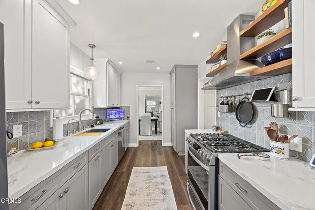 a view of walk in closet with clothes washer and dryer