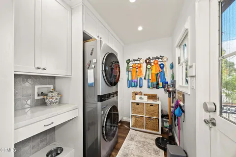 a living room with furniture a chandelier and a dining table