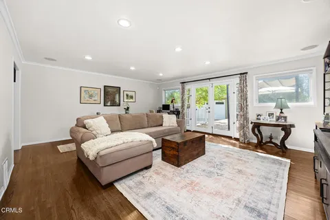 a living room with furniture window and flat screen tv