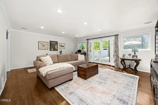 a living room with furniture window and flat screen tv