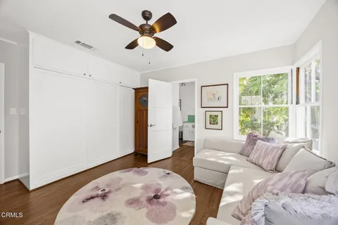 a bedroom with a bed dresser and a flat tv screen