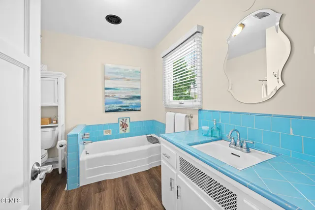 a view of a chair and table in backyard of the house