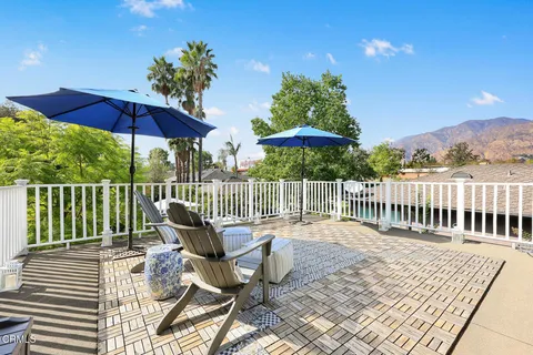 a view of house with outdoor seating and garden