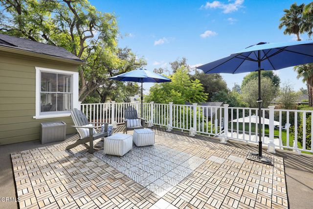 a view of a chair and tables in the backyard