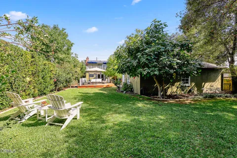 a view of a patio with a table chairs and a backyard