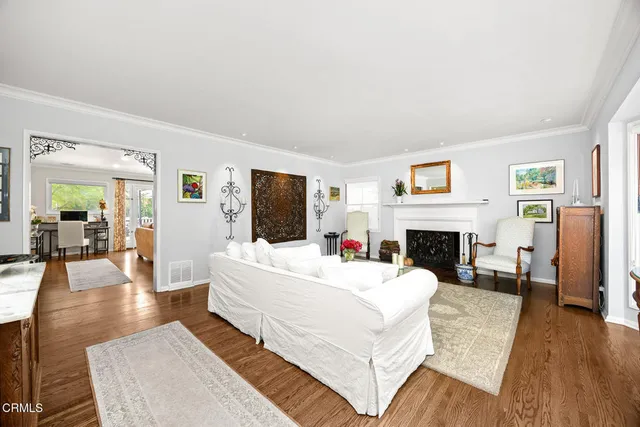 a living room with furniture a rug and a fireplace
