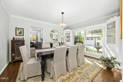 a kitchen with a sink a counter top space stainless steel appliances and cabinets
