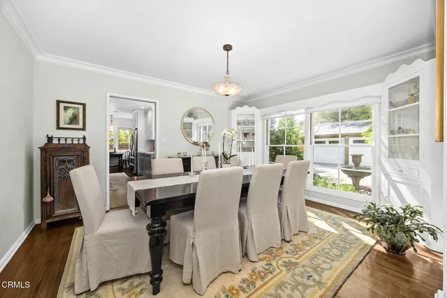 a kitchen with a sink a counter top space stainless steel appliances and cabinets