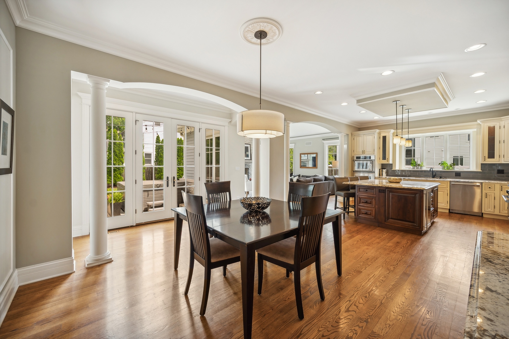 2548 Glenview Road Glenview, IL 60025 - Photo 11 of 39 a kitchen with stainless steel appliances kitchen island granite countertop a dining table chairs and white cabinets