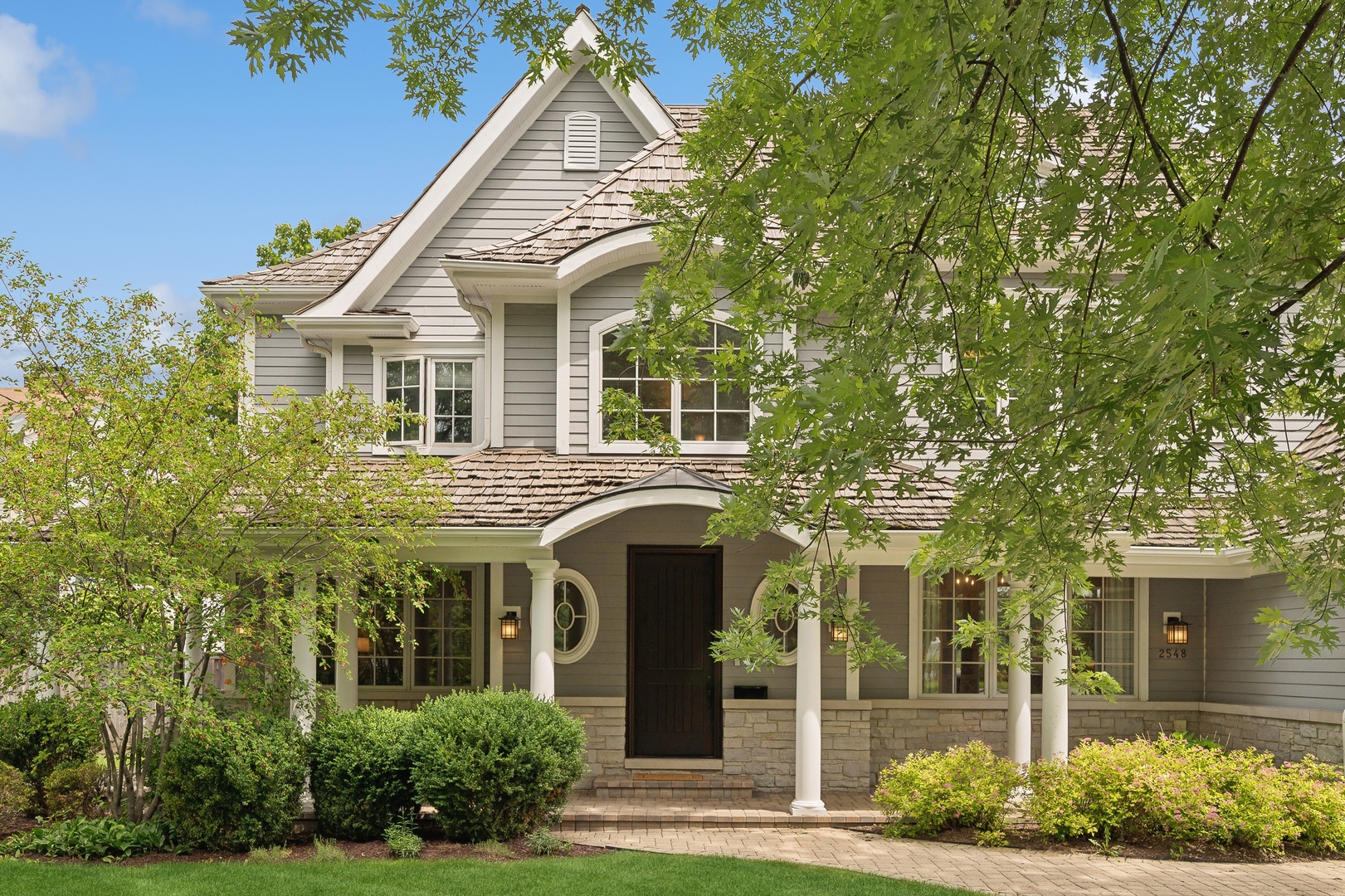 2548 Glenview Road Glenview, IL 60025 - Photo 2 of 39 a view of a white house with a small yard and plants