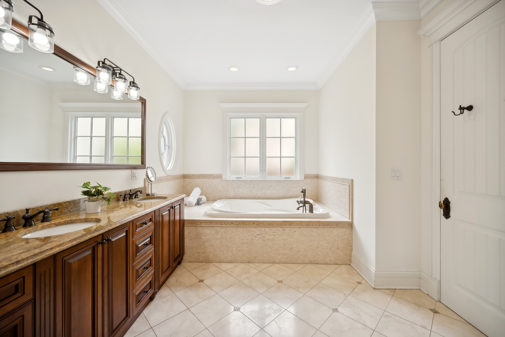2548 Glenview Road Glenview, IL 60025 - Photo 22 of 39 a spacious bathroom with a bathtub sink and mirror