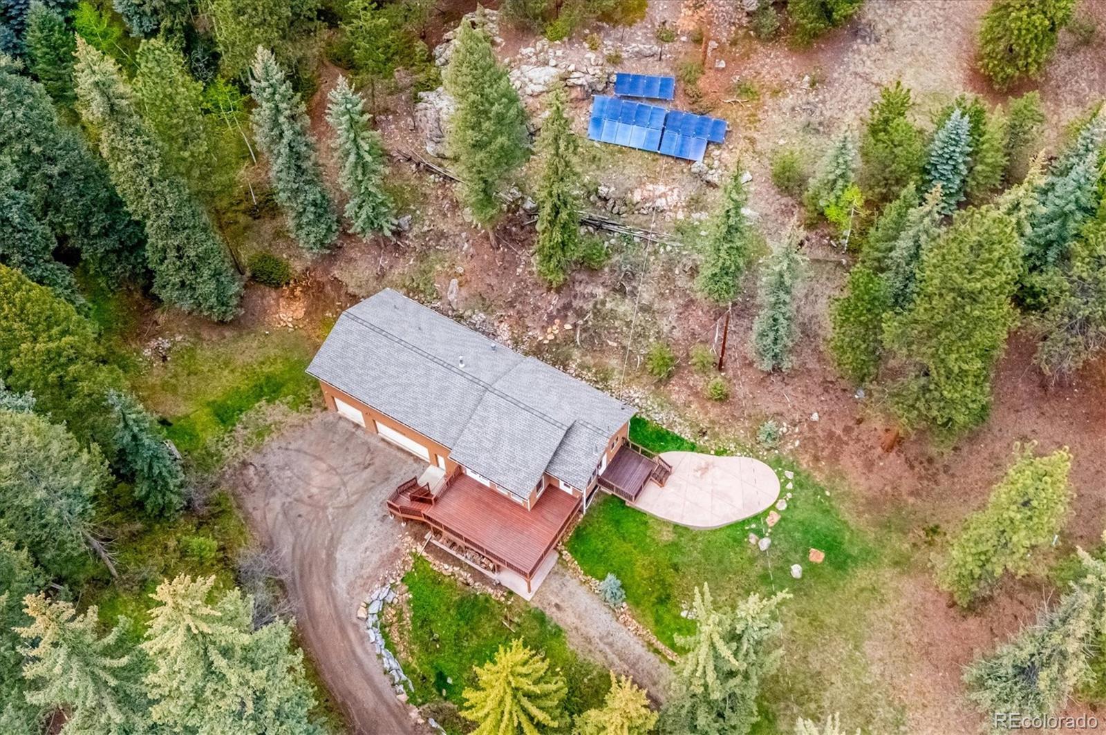 6747 South Brook Forest Road Evergreen, CO 80439 - Photo 43 of 49 an aerial view of a house with yard swimming pool and outdoor seating