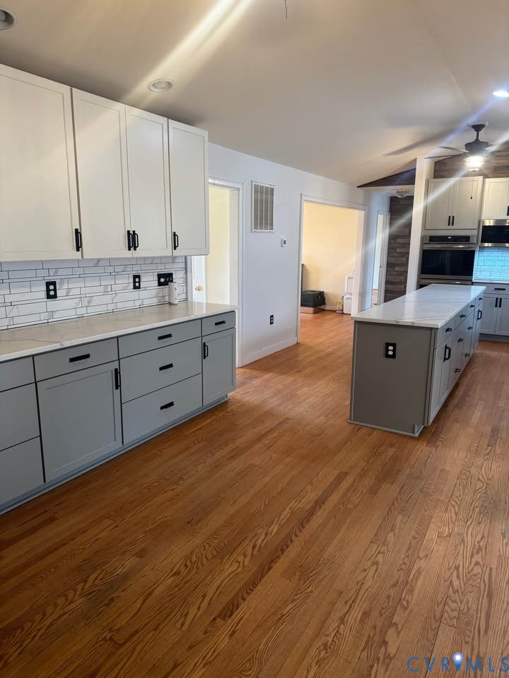 15390 Moores Mill Road Ruther Glen, VA 22546 - Photo 5 of 19 Kitchen featuring gray cabinets, decorative backsp