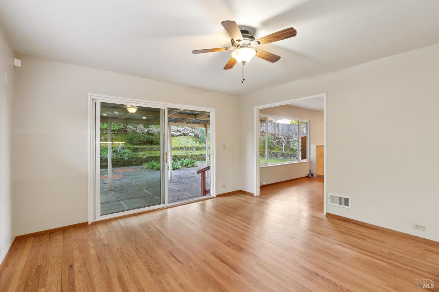 561 Olive Avenue Novato, CA 94945 - Photo 11 of 50 a view of an empty room with wooden floor and a window