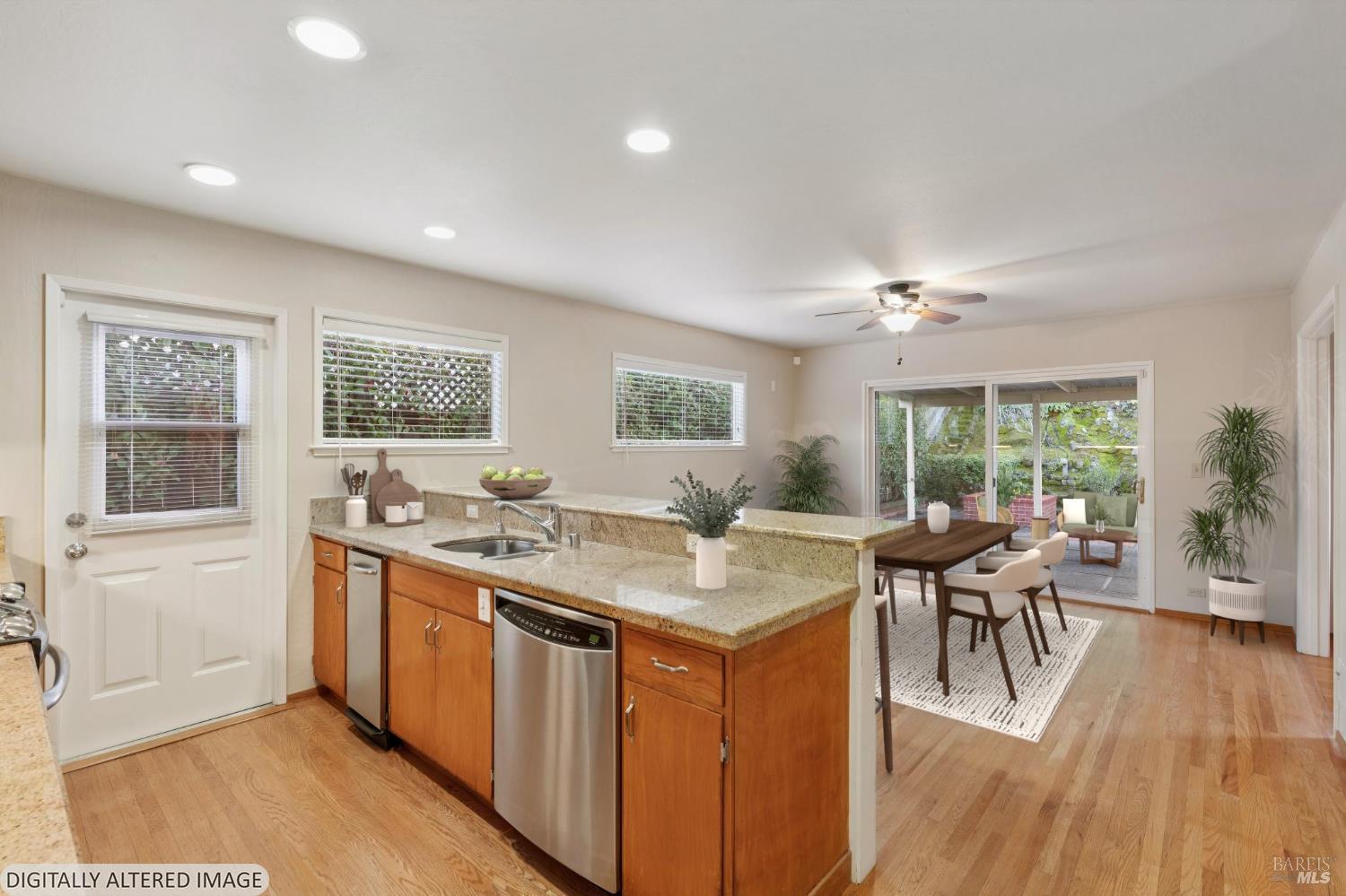 561 Olive Avenue Novato, CA 94945 - Photo 12 of 50 a view of a kitchen counter top space with wooden floor and stainless steel appliances