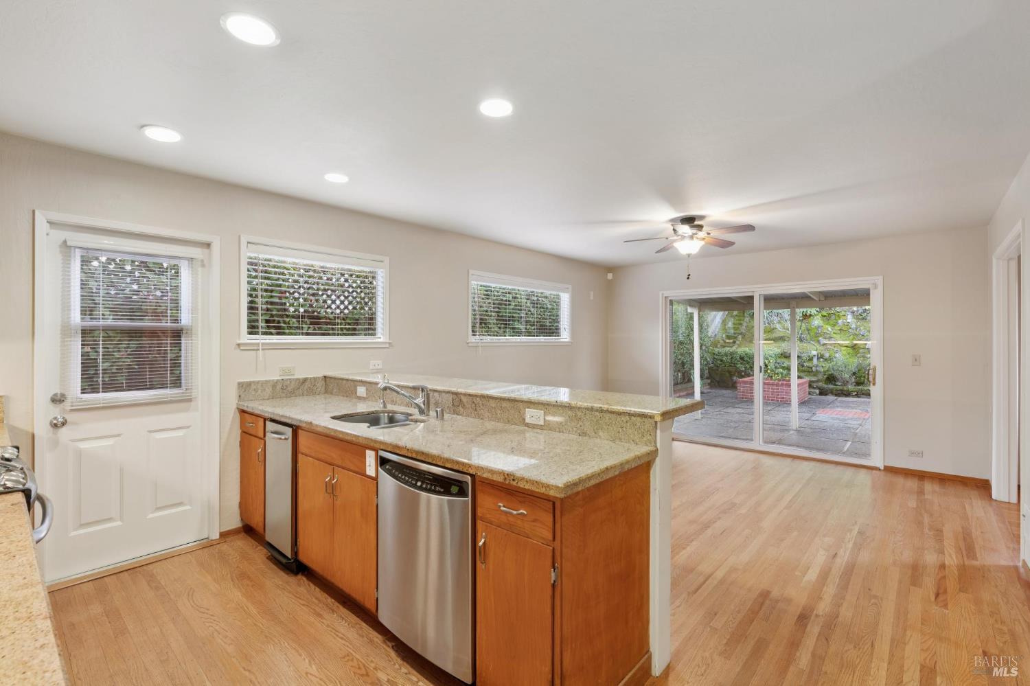 561 Olive Avenue Novato, CA 94945 - Photo 13 of 50 a kitchen with stainless steel appliances granite countertop a stove and a wooden floors