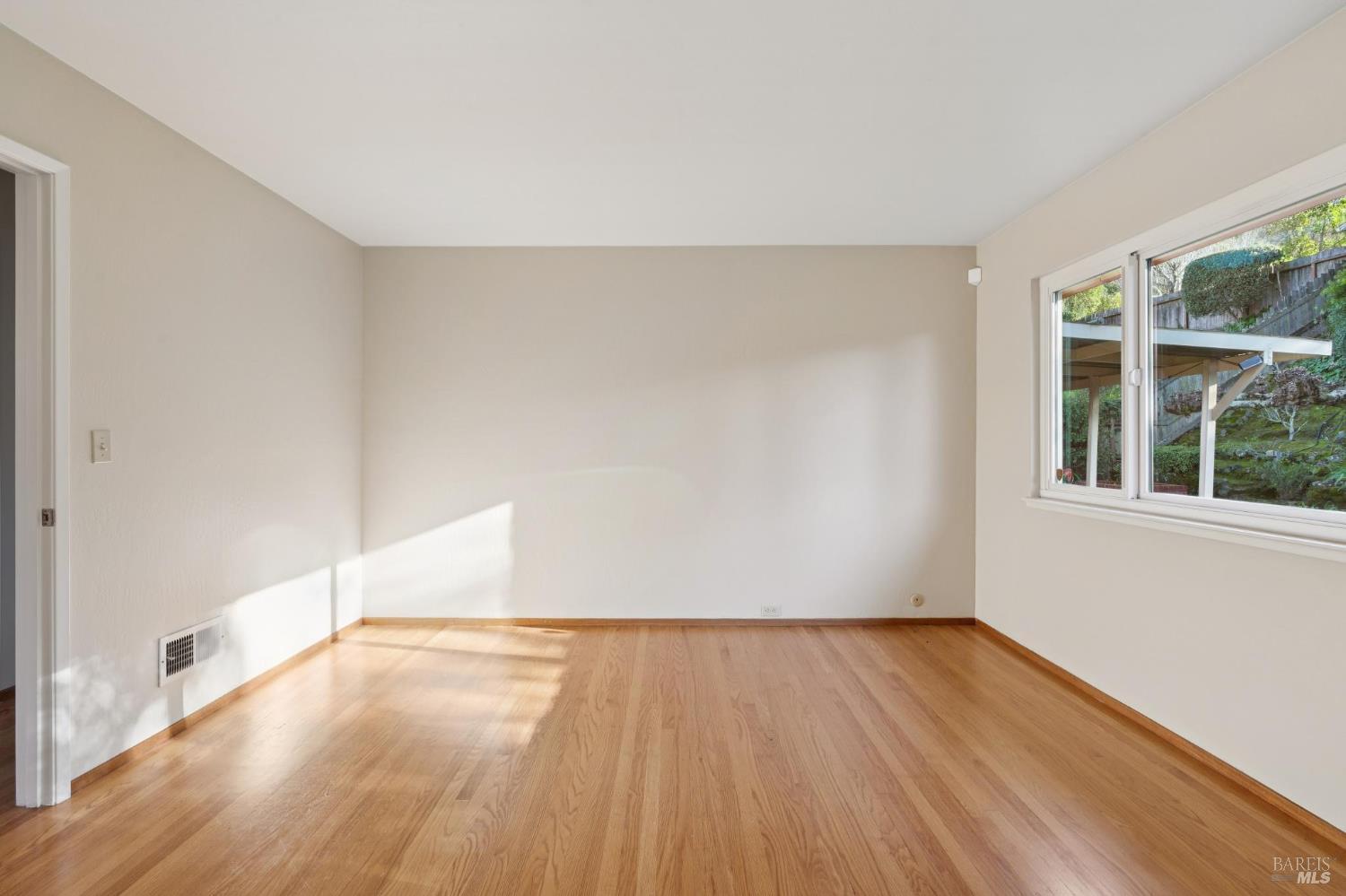 561 Olive Avenue Novato, CA 94945 - Photo 21 of 50 an empty room with wooden floor and windows