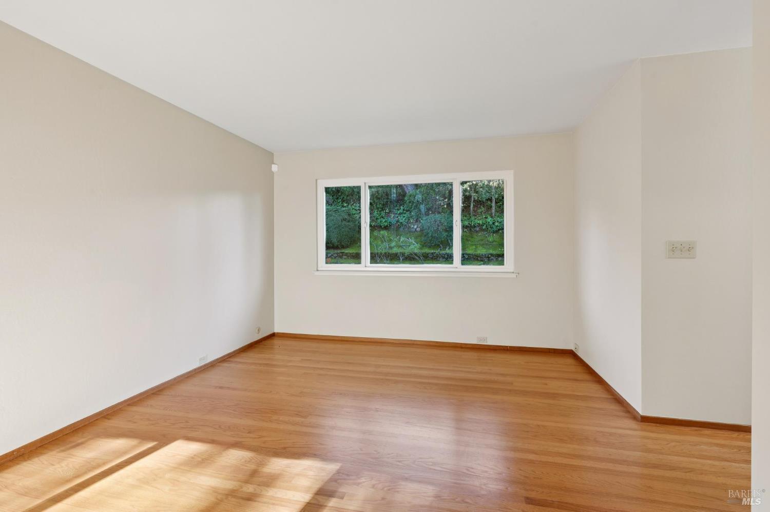 561 Olive Avenue Novato, CA 94945 - Photo 24 of 50 an empty room with wooden floor and windows