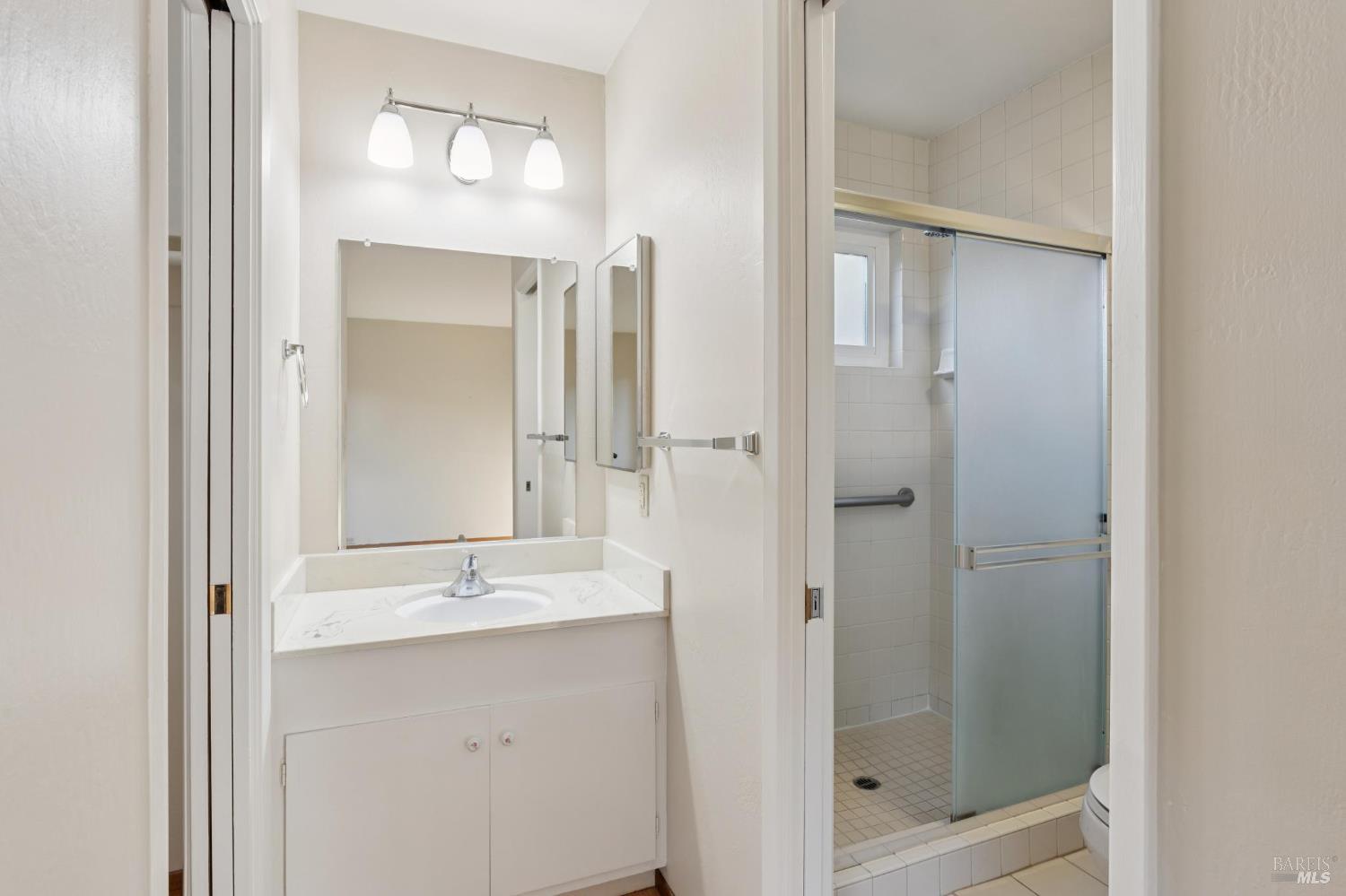 561 Olive Avenue Novato, CA 94945 - Photo 27 of 50 a bathroom with a shower sink and mirror