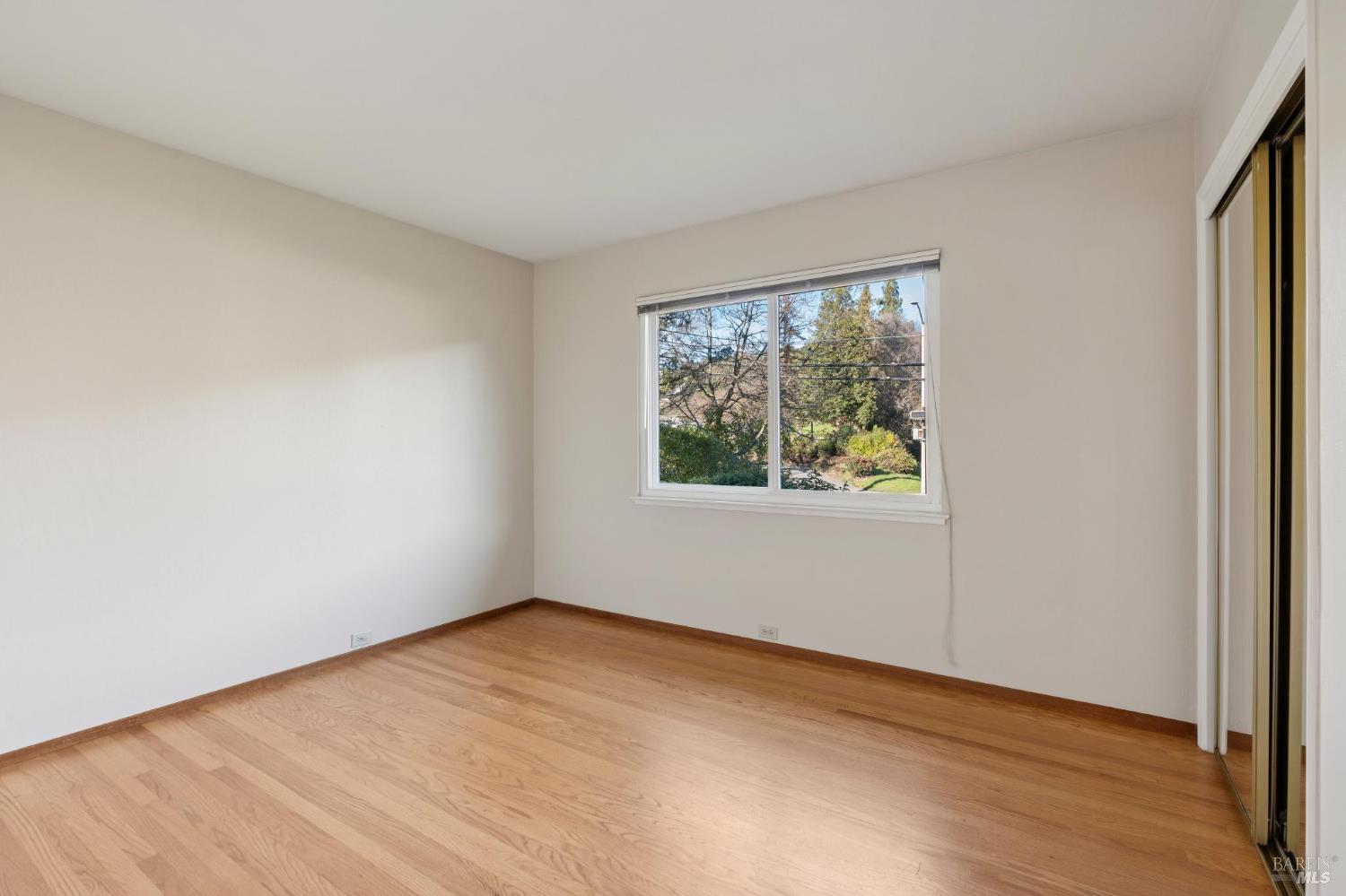 561 Olive Avenue Novato, CA 94945 - Photo 31 of 50 an empty room with wooden floor and windows
