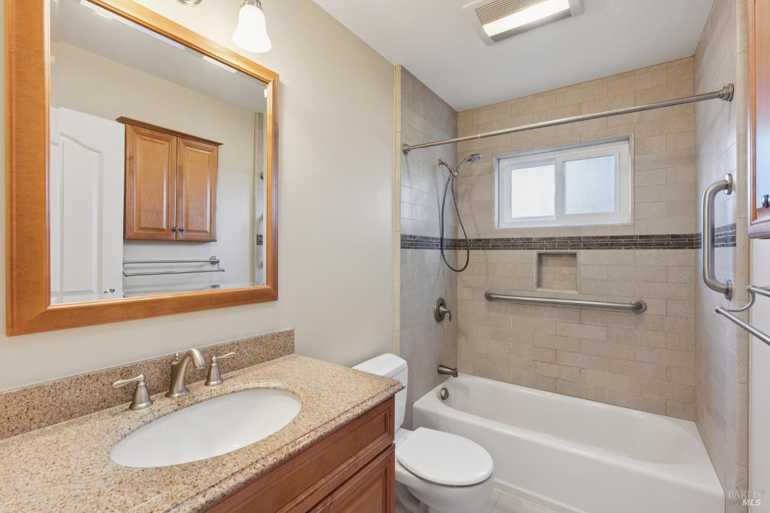 561 Olive Avenue Novato, CA 94945 - Photo 32 of 50 a bathroom with a granite countertop sink toilet and shower