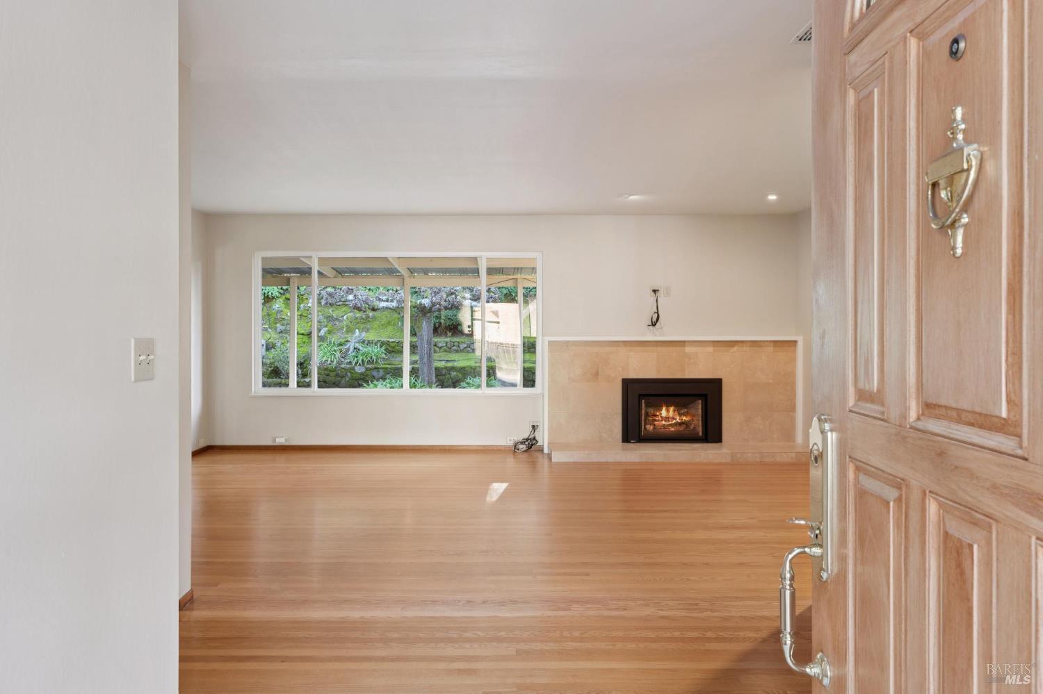 561 Olive Avenue Novato, CA 94945 - Photo 5 of 50 a view of a livingroom with a fireplace and window
