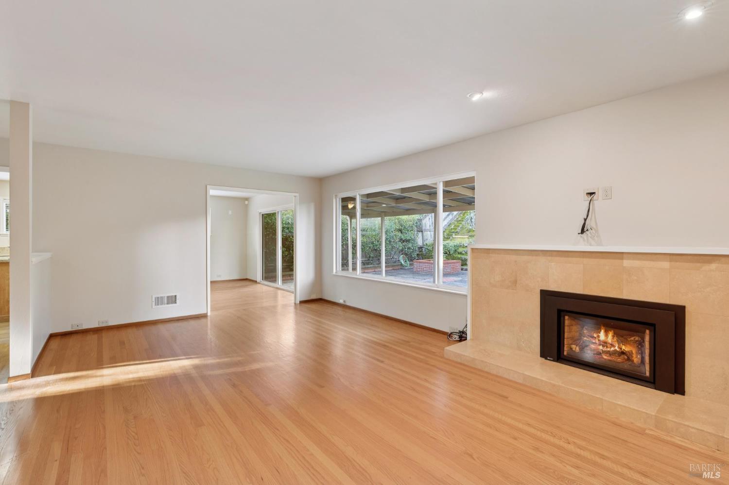 561 Olive Avenue Novato, CA 94945 - Photo 6 of 50 a view of an empty room with a fireplace and a window