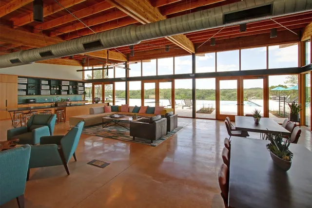 a living room with lots of furniture and a large window