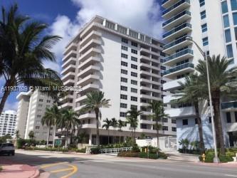 9225 Collins Avenue, Unit 403 Surfside, FL 33154 - Photo 1 of 19 a view of a tall building next to a road