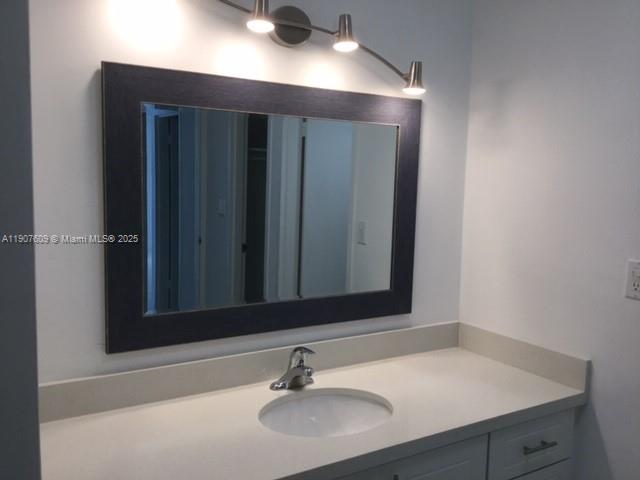 9225 Collins Avenue, Unit 403 Surfside, FL 33154 - Photo 12 of 19 a bathroom with a sink and a mirror
