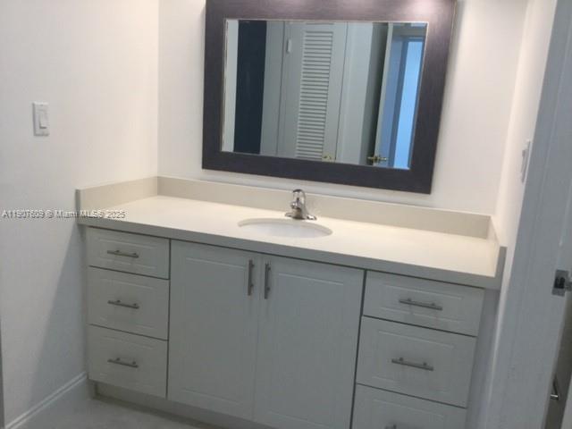 9225 Collins Avenue, Unit 403 Surfside, FL 33154 - Photo 13 of 19 a bathroom with a sink and a mirror
