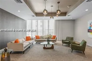 a living room with furniture and a chandelier