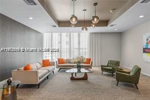 9225 Collins Avenue, Unit 403 Surfside, FL 33154 - Photo 3 of 19 a living room with furniture and a chandelier