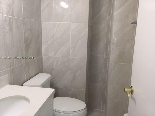 9225 Collins Avenue, Unit 403 Surfside, FL 33154 - Photo 8 of 19 a white toilet sitting next to a shower