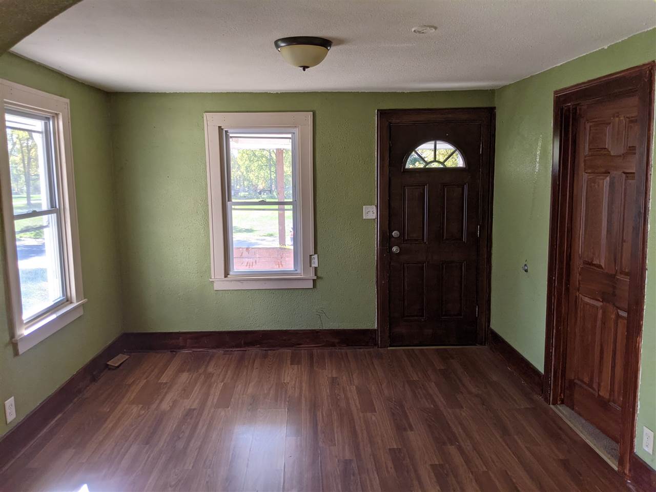 430 Barry Road Rockford, IL 61109 - Photo 5 of 13 an empty room with wooden floor and windows